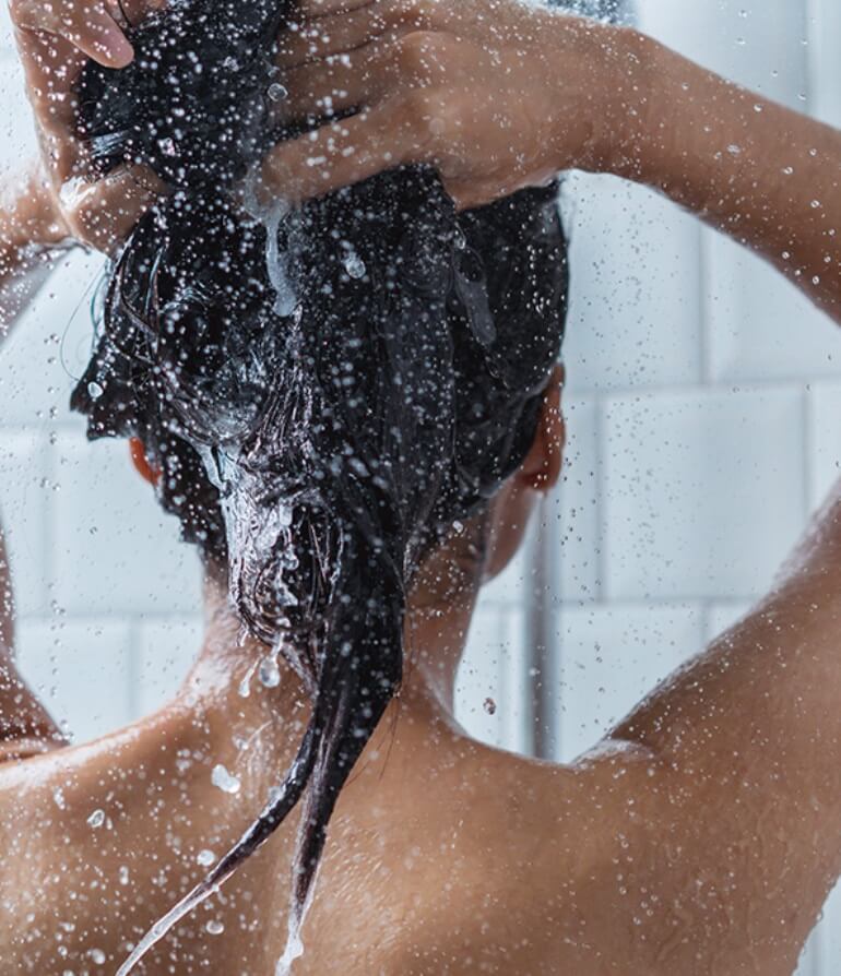 Girl washing hair in shower
